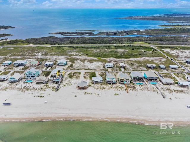 drone / aerial view featuring a beach view and a water view