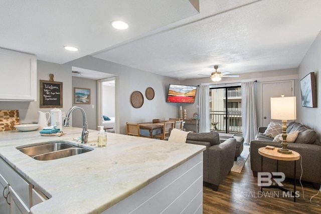 kitchen featuring white cabinetry, sink, dark wood-type flooring, and ceiling fan