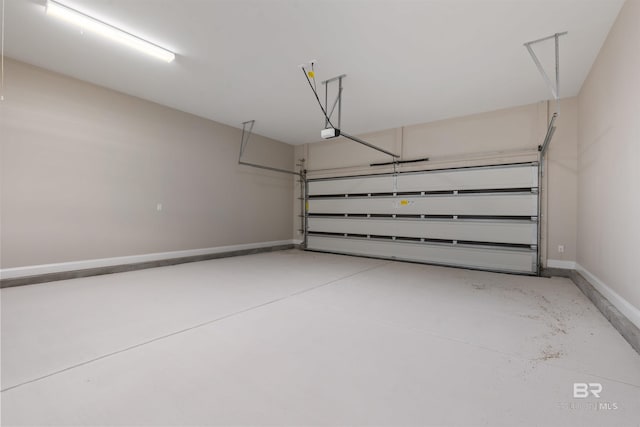 33861 Rutland Ln, Spanish Fort, AL 36527 - garage featuring baseboards and a garage door opener