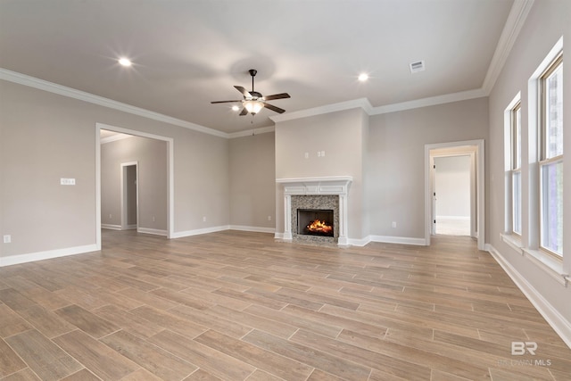 33861 Rutland Ln, Spanish Fort, AL 36527 - unfurnished living room with ceiling fan, a premium fireplace, light wood-type flooring, baseboards, and ornamental molding
