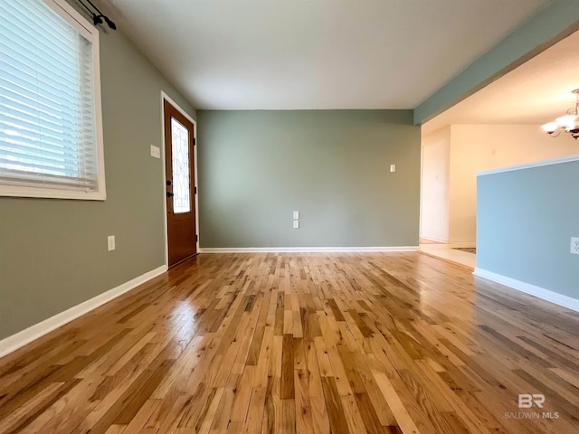 interior space featuring a chandelier and light wood-type flooring