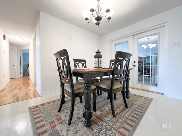 dining area featuring wood-type flooring and a chandelier