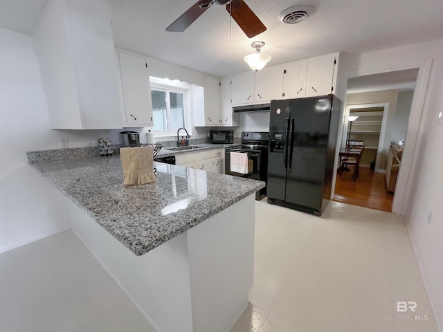 kitchen with black appliances, light stone counters, white cabinets, kitchen peninsula, and ceiling fan