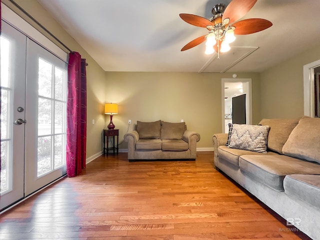 living room featuring ceiling fan, light wood-type flooring, and french doors