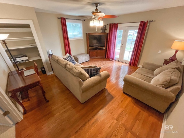 living room with wood-type flooring, ceiling fan, and french doors