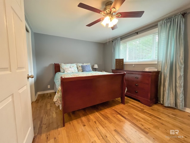 bedroom with light hardwood / wood-style floors and ceiling fan