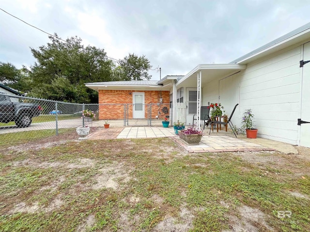 back of house with a patio