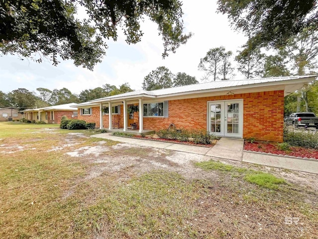 view of front of house featuring french doors and a front yard