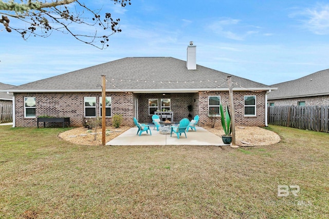 back of house featuring a patio area and a lawn