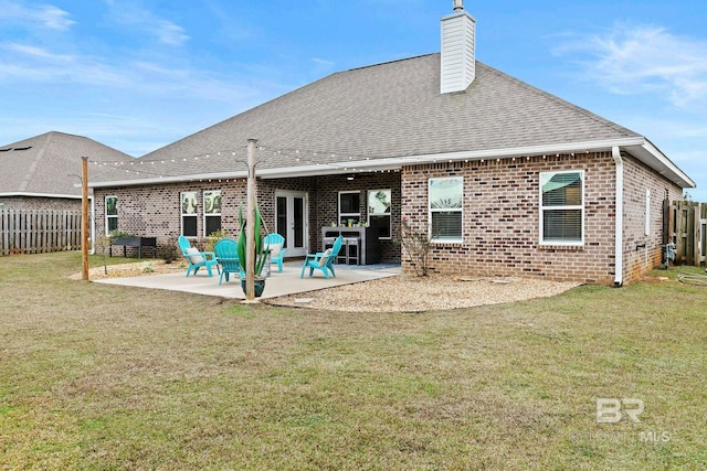 back of house with french doors, a yard, and a patio area