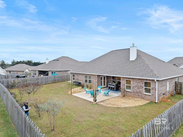 back of property featuring a yard and a patio