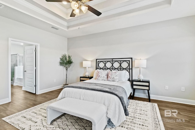 bedroom with a raised ceiling, ceiling fan, dark hardwood / wood-style flooring, and ornamental molding