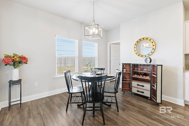 dining room featuring a notable chandelier and dark wood-type flooring