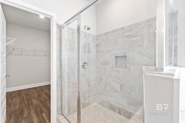 bathroom featuring hardwood / wood-style floors and walk in shower