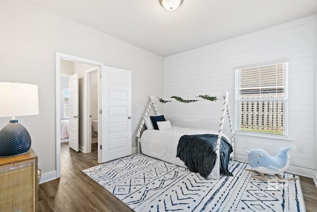 bedroom with dark hardwood / wood-style floors