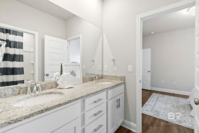 bathroom featuring a shower with curtain, vanity, and hardwood / wood-style flooring