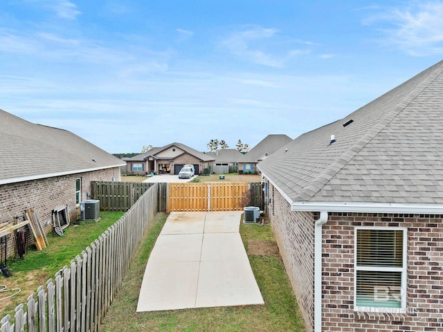 view of yard featuring a patio and central AC