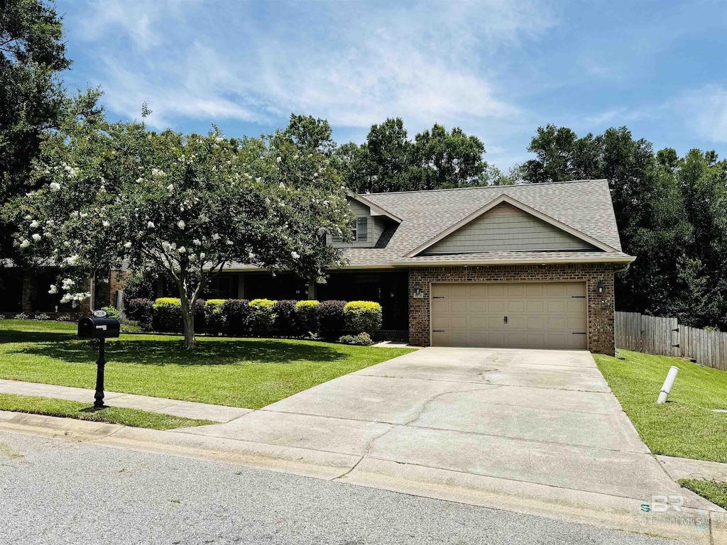 28138 Turkey Branch Dr, Daphne, AL 36526 - view of front facade with an attached garage, concrete driveway, brick siding, and roof with shingles