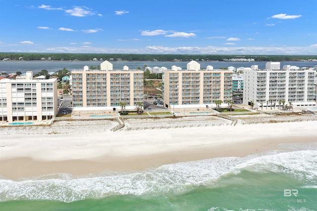 bird's eye view with a water view and a beach view