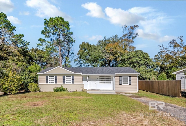 ranch-style home featuring covered porch and a front yard