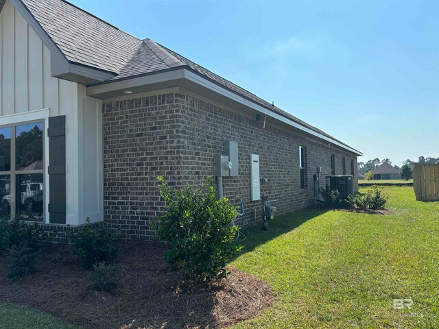 view of home's exterior featuring a lawn and central AC unit