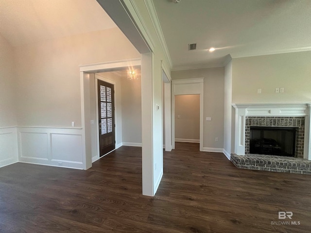 unfurnished living room featuring a fireplace, dark hardwood / wood-style flooring, and ornamental molding