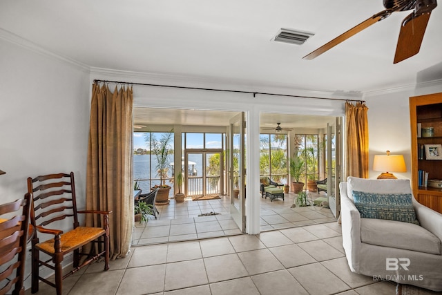doorway to outside with a water view, visible vents, a ceiling fan, ornamental molding, and light tile patterned floors