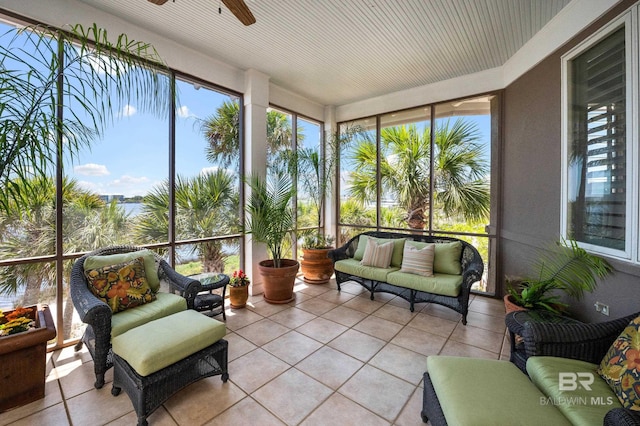 sunroom featuring an outdoor living space, a ceiling fan, and tile patterned floors
