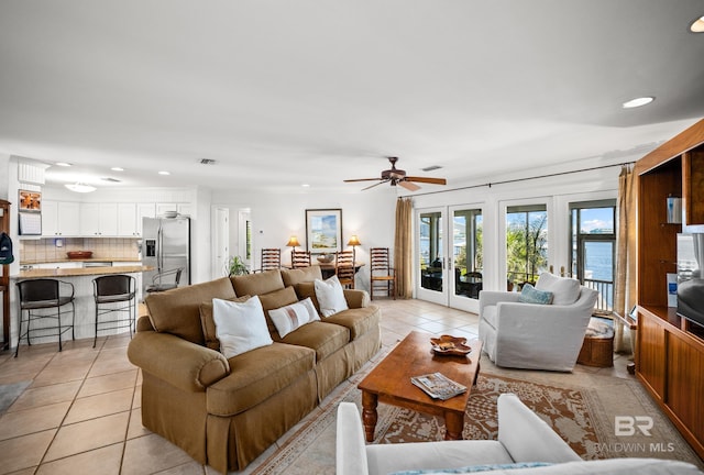 living area with french doors, visible vents, recessed lighting, a ceiling fan, and light tile patterned floors