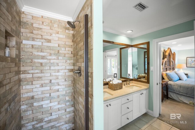 ensuite bathroom featuring a shower stall, visible vents, ornamental molding, a sink, and ensuite bathroom
