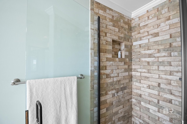bathroom featuring a shower stall and crown molding