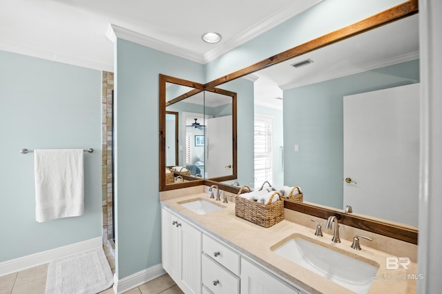 ensuite bathroom with visible vents, crown molding, tile patterned floors, and a sink