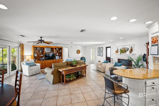living area featuring a ceiling fan, light tile patterned flooring, a fireplace, visible vents, and recessed lighting