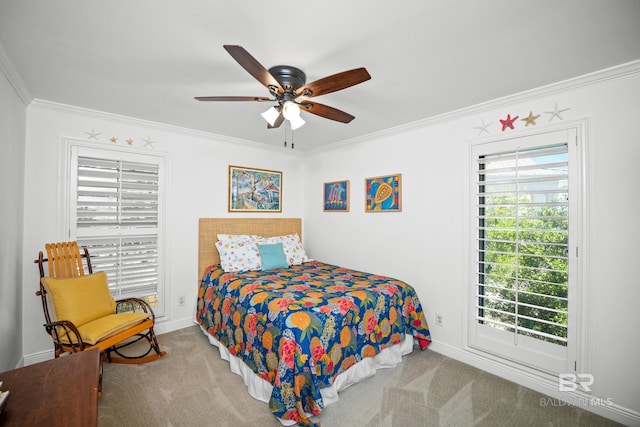 carpeted bedroom with crown molding, baseboards, and a ceiling fan