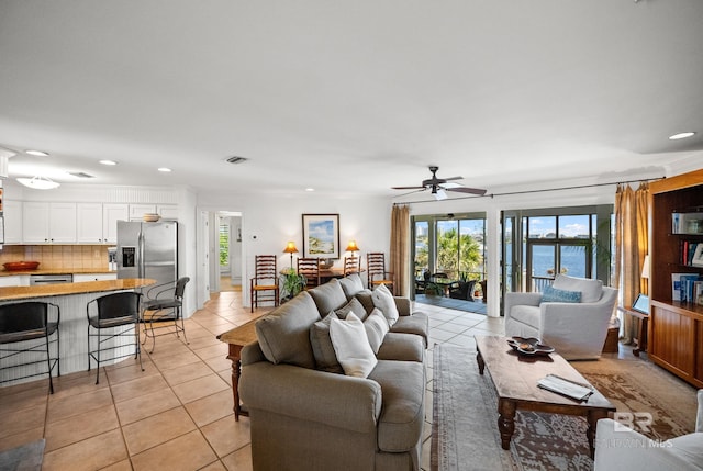 living area with ceiling fan, recessed lighting, visible vents, and light tile patterned floors