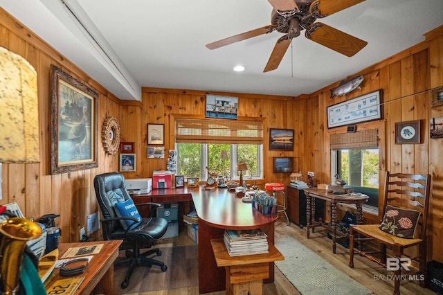 office space featuring recessed lighting, wooden walls, wood finished floors, and a ceiling fan