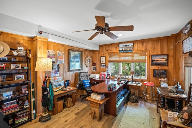 office space with a ceiling fan, wood walls, and a healthy amount of sunlight