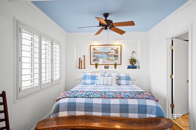 bedroom featuring ceiling fan and crown molding