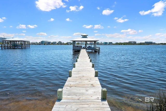 view of dock featuring a gazebo and a water view