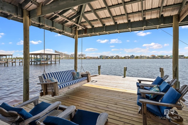 view of dock featuring a gazebo and a water view