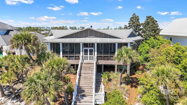 exterior space with a sunroom and stairway