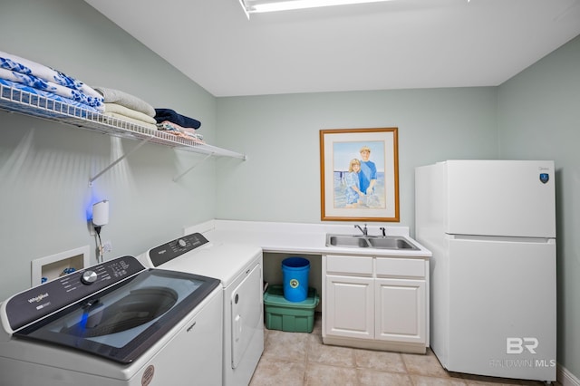 clothes washing area with independent washer and dryer, a sink, light tile patterned floors, and cabinet space