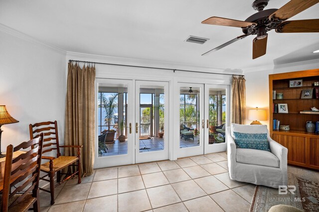 living area featuring french doors, visible vents, ornamental molding, and a ceiling fan