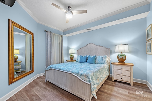 bedroom with ceiling fan, ornamental molding, a textured ceiling, and hardwood / wood-style floors