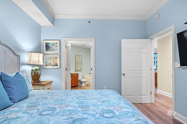 bedroom featuring connected bathroom, crown molding, and light hardwood / wood-style floors