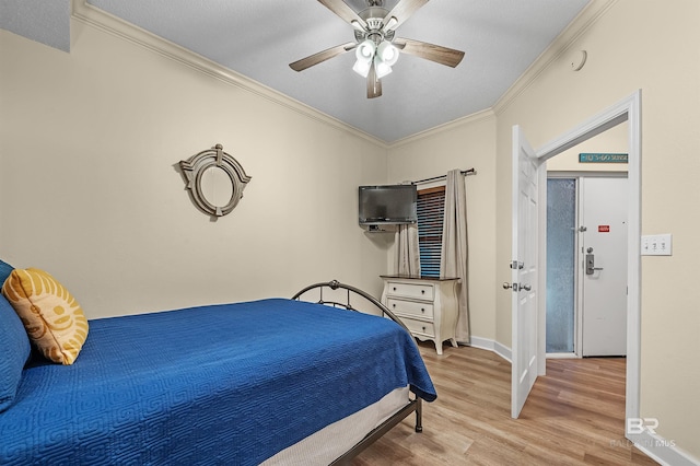 bedroom with crown molding, ceiling fan, and light hardwood / wood-style flooring