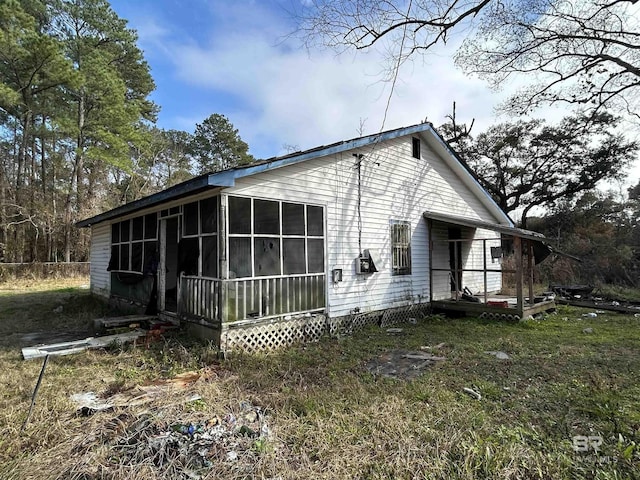 view of side of property featuring a sunroom