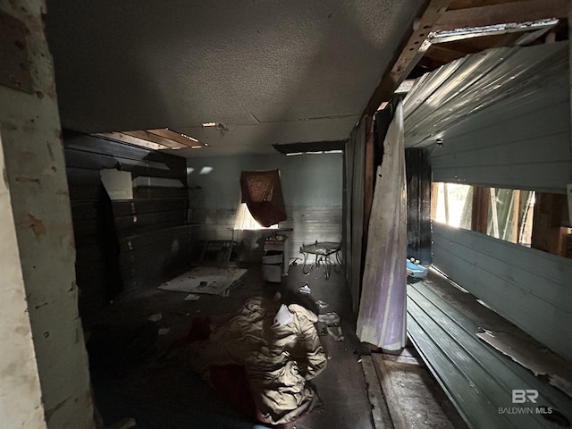 miscellaneous room with a textured ceiling