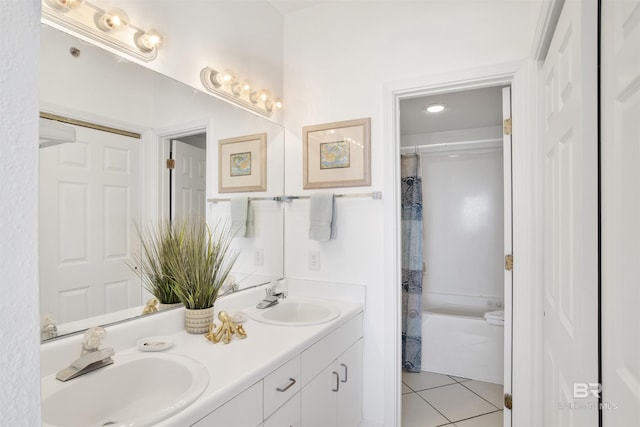 bathroom featuring tile patterned flooring, vanity, and a washtub