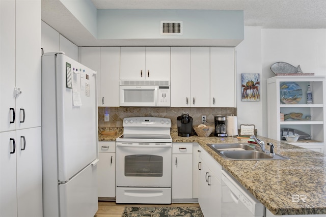 kitchen featuring sink, tasteful backsplash, stone countertops, white appliances, and white cabinets